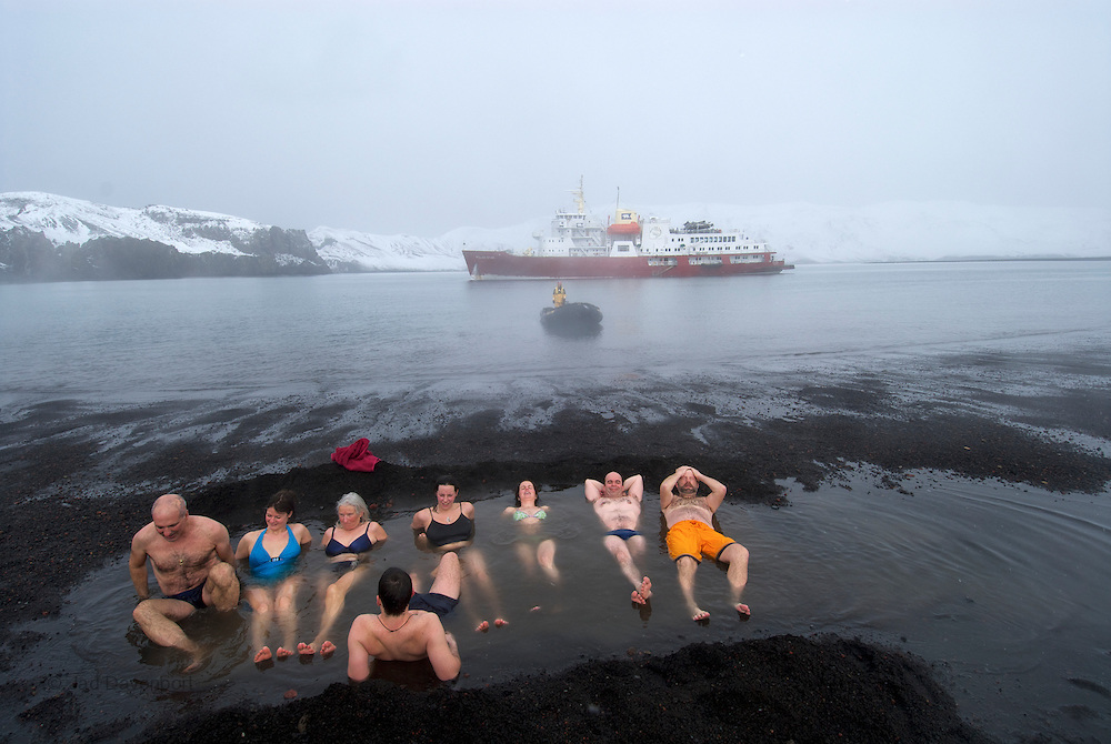 Passengers from the MV Polar Star, an expedition cruise ship, bathing in the thermal vents at Deception Island, a dormant caldera.